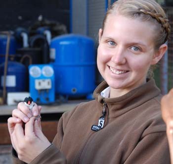 Laken Ciooper holds a house sparrow during her recent research expedition in Kenya