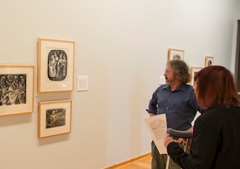 Joel Gibbs (left) and Roann Barris (right) view the exhibit