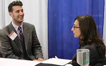 Radford University student Ben Siegel speaks with a recruiter at the Education Career Fair on March 17.