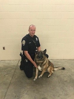 Officer Justin Miller '10, left, and Max, right.