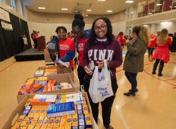 Student volunteers pack bags with canned goods during the second annual Radford Gives Back food drive.