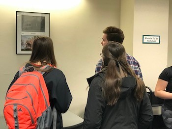 Students wander the "Then and Now" gallery in McConnell Library.