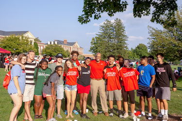 New members of the Radford Family have their photo taken with President Brian O. Hemphill at a picnic after New Student Convocation.