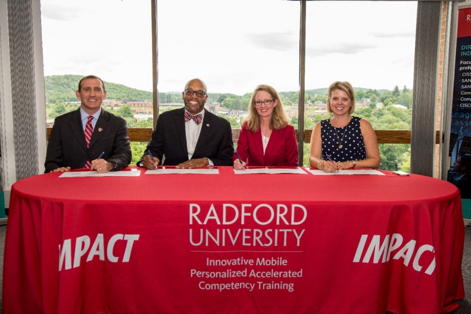 IMPACT Executive Director Matt Dunleavy, Ph.D. (from left), President Hemphill, New College Institute Executive Director Leanna Blevins and Assistant Director of Academics and Communications Melany Stowe 