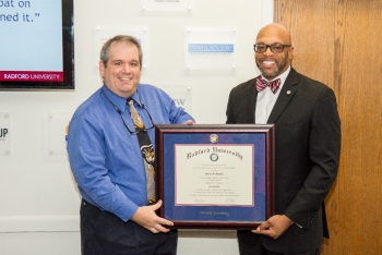 Stacey Howard '04, IMPACT's first graduate, receives a formal certificate from Radford University President Brian O. Hemphill.
