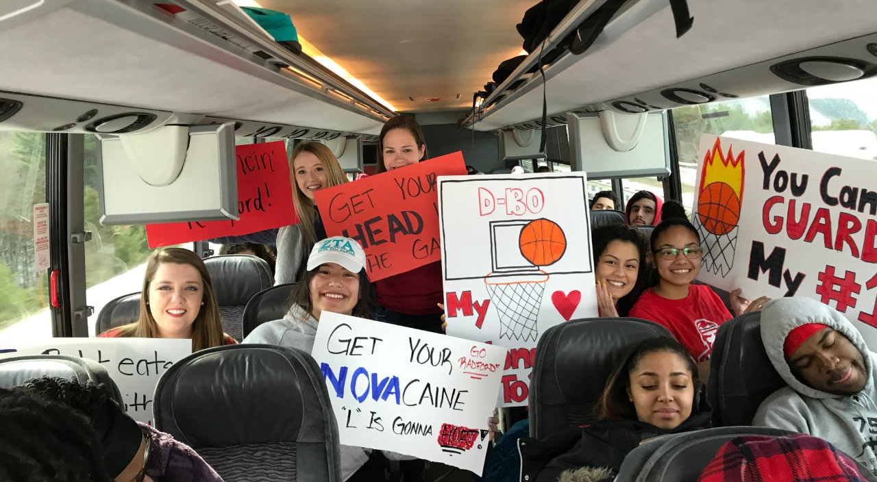 Students show off their completed signs on the way to Pittsburgh for the first round of the NCAA Tournament.