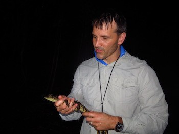 Green holding a baby alligator.