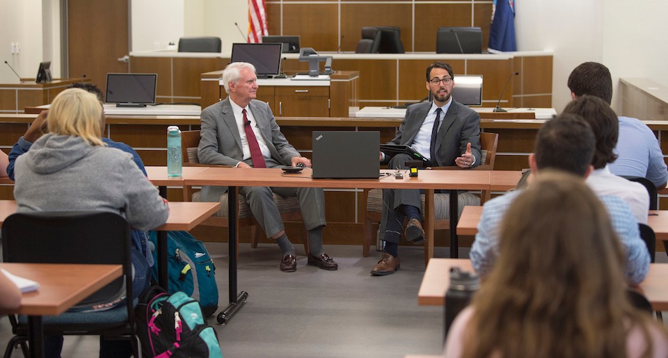 Radford University Assistant Professor of Criminal Justice, Luke Hunt, right, speaks with Federal Judge James P. Jones, left, during the Radford University Prelaw Society event in the courtroom inside the College of Humanities and Behavioral Sciences.