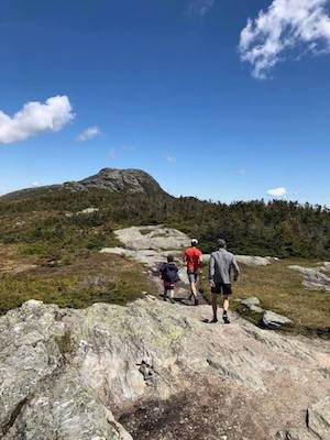Hunt, center, trail running with his son, Henry, left, and his father, right, at Vermont's Mt. Mansfield.