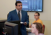 Finance faculty member Abhay Kaushik (left) works with students in the Trading Room located inside Kyle Hall, home of the College of Business and Economics.