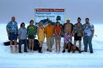 Student researchers wear Hawaiian-themed clothes in the snow.