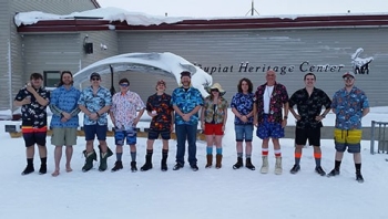Student researchers wear Hawaiian-themed clothes in the snow.