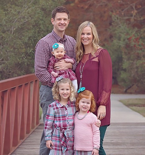 Corey Reed with wife, Erin, and children (clockwise from bottom) Graelyn, Leighton and Brennan.