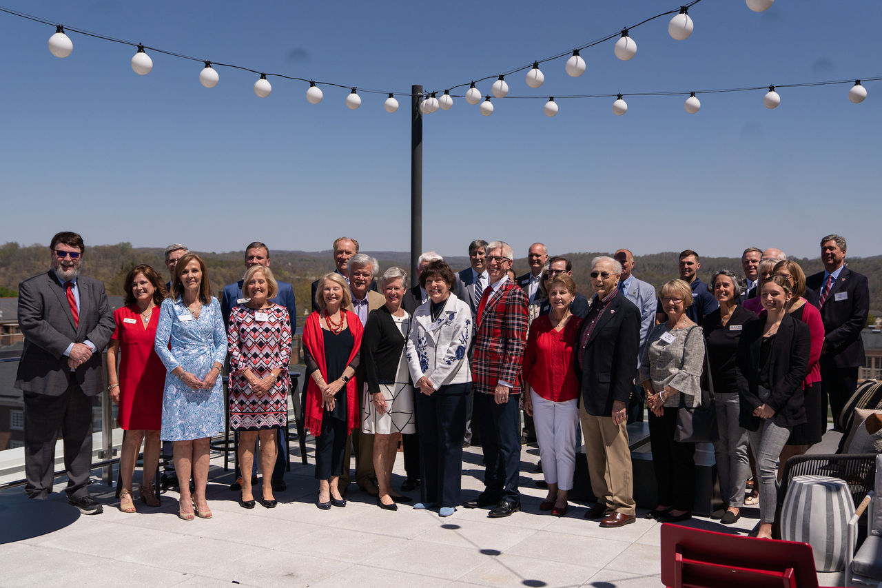 Attendees of the Campaign Steering Committee meeting gather for a photo on the rooftop of The Highlander.