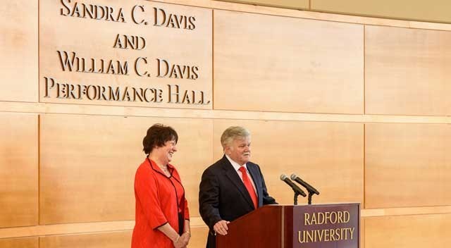 Sandra C. Davis and William C. Davis address an audience in the Sandra C. Davis and William C. Davis Performance Hall