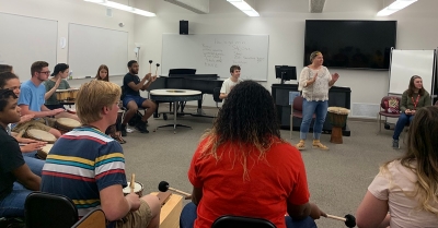 Community of artists members participate in a music therapy workshop in Porterfield Hall. 