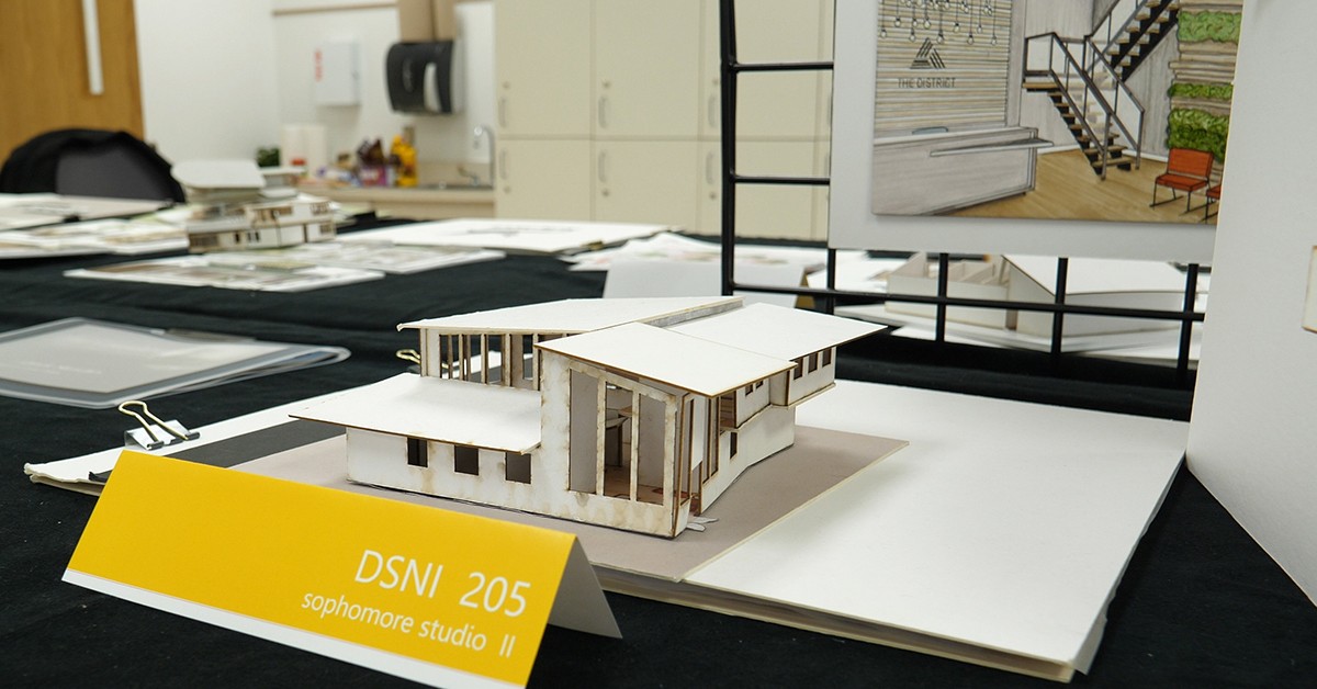 A student building model on display for CIDA representatives during their December 2019 accreditation review visit.