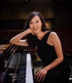 Pianist Anchie Donn poses at a piano