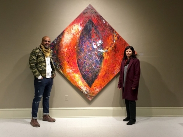 Exhibiting artist Masud Olufani (left) poses with Dr. Halide Salam (right) beside her original art titled 'Remembering Jesus.'