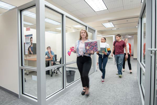 picture of students walking by a study room in McConnell library
