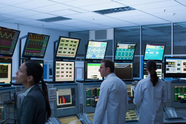 Employees in a computer monitoring lab