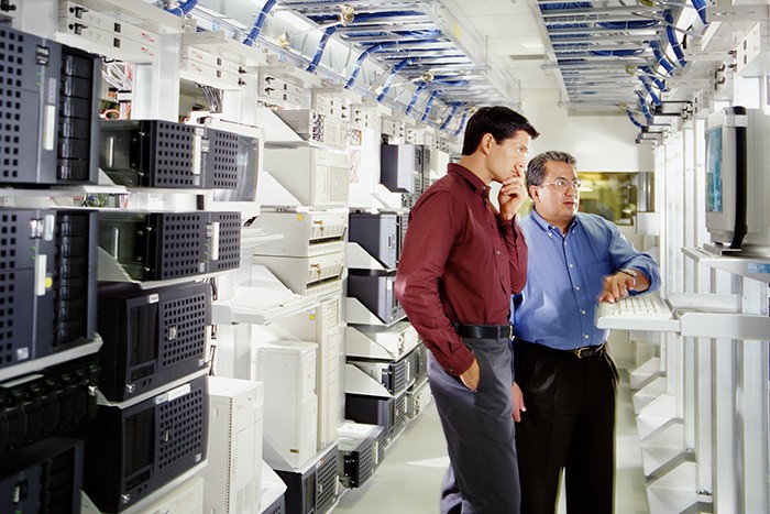 Men in computer server room