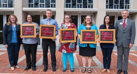 President Lepre (left) and interim Provost Rogers (right) congratulate winners Lau, Anderson, Ren, Winfrey and Lee.