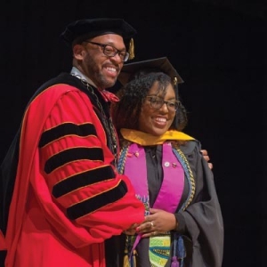 President Hemphill poses with a graduating student at Radford University's Winter Commencement 2017