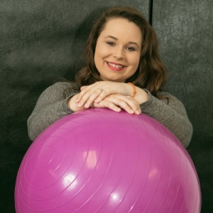 Radford University student Lauren Boush poses with a therapy ball designed for treating individuals with cerebral palsy