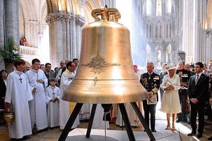 In theAt a christening ceremony in nave of Normandy's Bayeux Cathedral, Great Britain's Queen Elizabeth served as senior godparent while Sperry Grills, a junior godparent, looked on. 