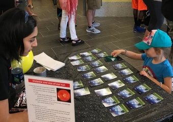 Sarah Garza (left) and Hailey Burnett (right) play a NASA-themed match game.  