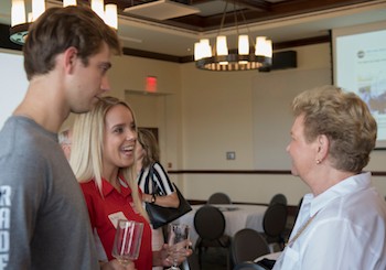 Brock Barnes, left, and Brittney Stowe, center, speak with BOV and Radford University Foundation member Georgia Ann Snyder-Falkinham.