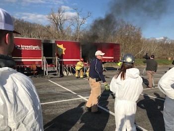 Todd Jones, center, talks to the class during the arson investigation exercise.