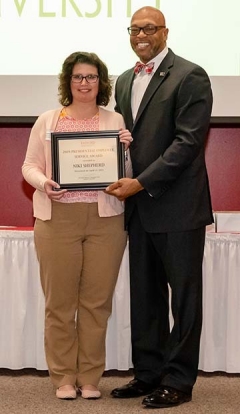 President Brian O. Hemphill, Ph.D. congratulates one of two 2019 Presidential Service Award winners, Niki Shepherd, at Radford University's annual Employee Service Awards Luncheon on April 11 in the Muse Banquet Hall. 