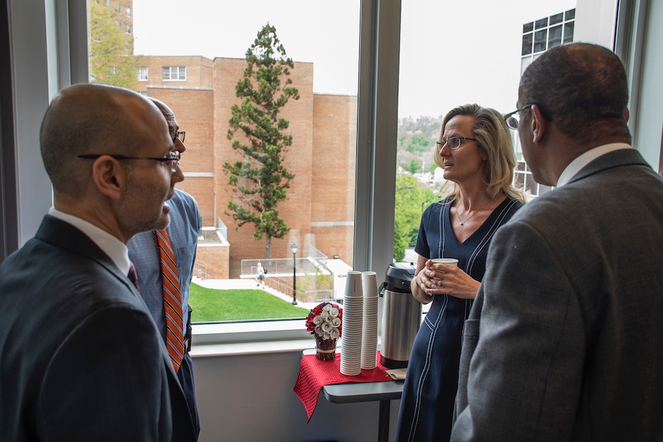 Roberto Santos, Ph.D., left, and Rachel Santos, Ph.D., center-right, talk with local agencies during the opening of the Center.