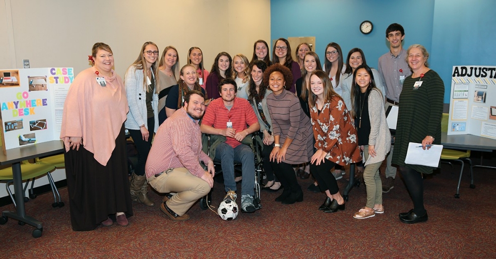 Occupational Therapy Assistant students with assistant professor Leah Savelyev (left) at the case study presentations event on Dec. 3.