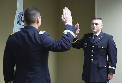 Clatterbuck, right, take the Oath of Office from Cpt. Patrick Zebrowski.