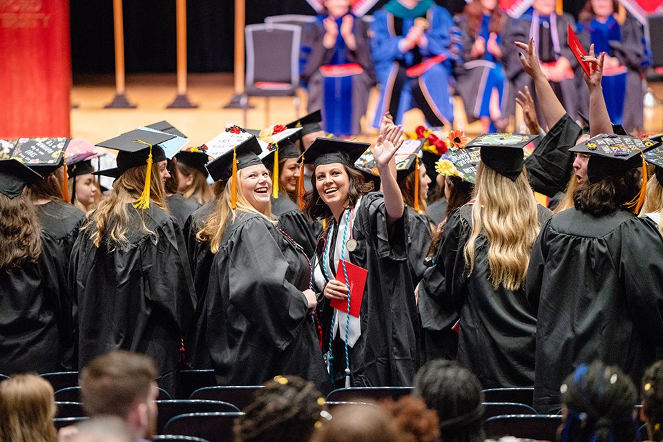 Students wave to to their families and friends during the Commencement ceremonies on May 10-11.