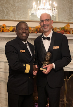 Matthew Oyos, right, pictured with Rear Adm. Cedric Pringle after receiving the 2019 Annual Book Award from the Theodore Roosevelt Association.