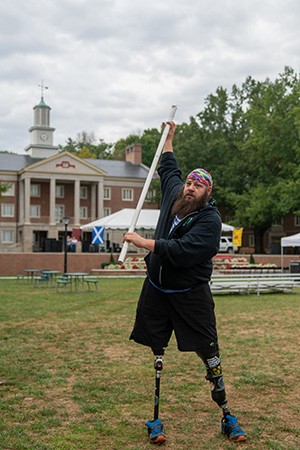 Matthew Hall MSW ’03 stretches before competing in the Highland Games.