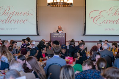 Nancy Artis '73 speaks during the Partners in Excellence luncheon.