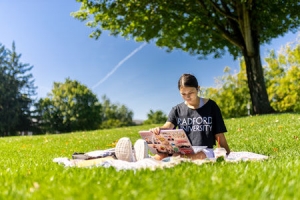 A student studies outside on campus in Radford.