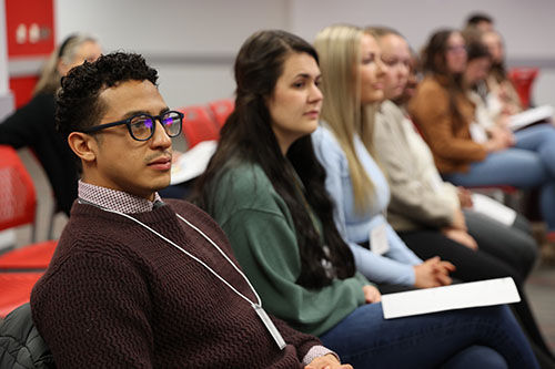 BSN student Ruben Carlo listens to the introduction of the IPE case study activity.