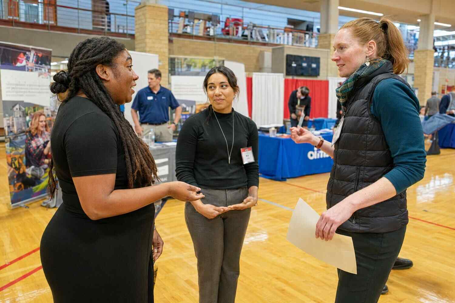 Three people talking at a showcase setting