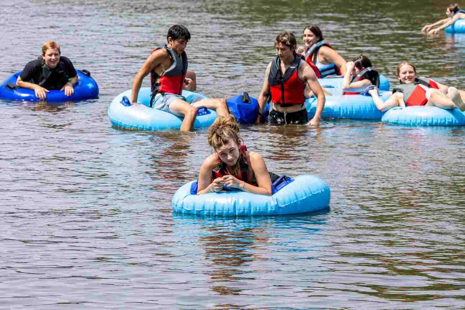 students riding inner tubes on the New River
