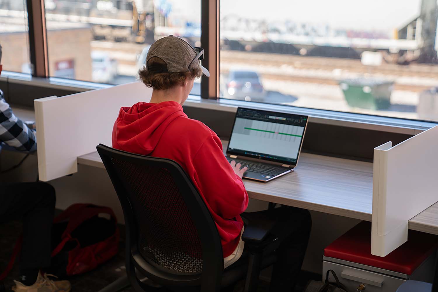 student at computer and desk