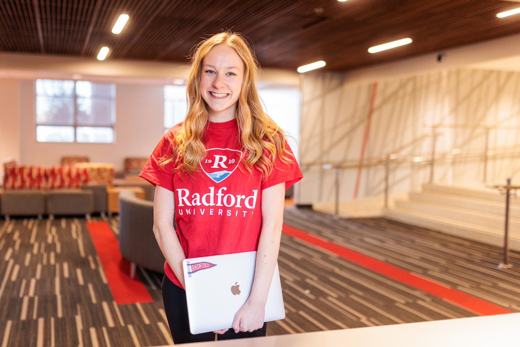 student holding a laptop