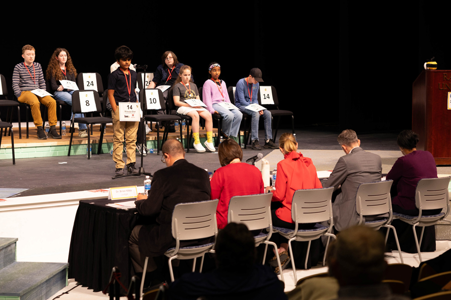 Spellers compete in the late rounds as judges evaluate their answers