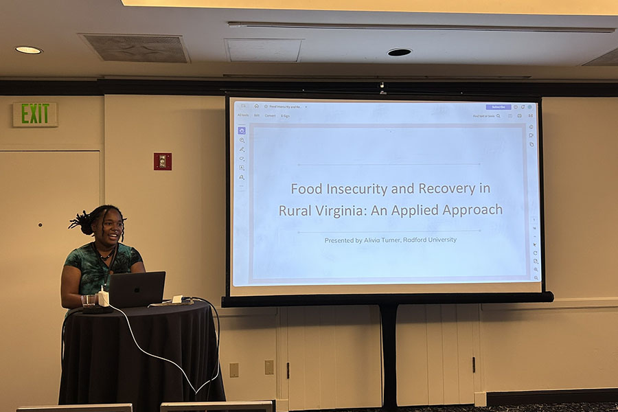 Alivia Turner presents at the rural sociology conference.