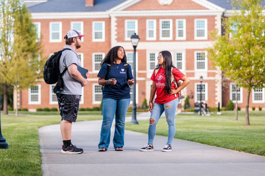 Students standing in front of Reed/Curie Halls on campus
